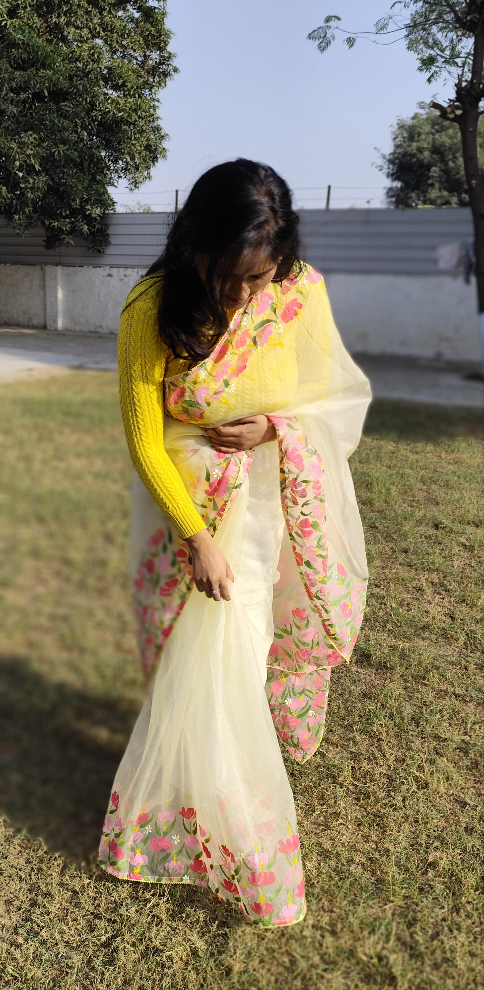 Hand painted pastel yellow saree with pink flowers.
