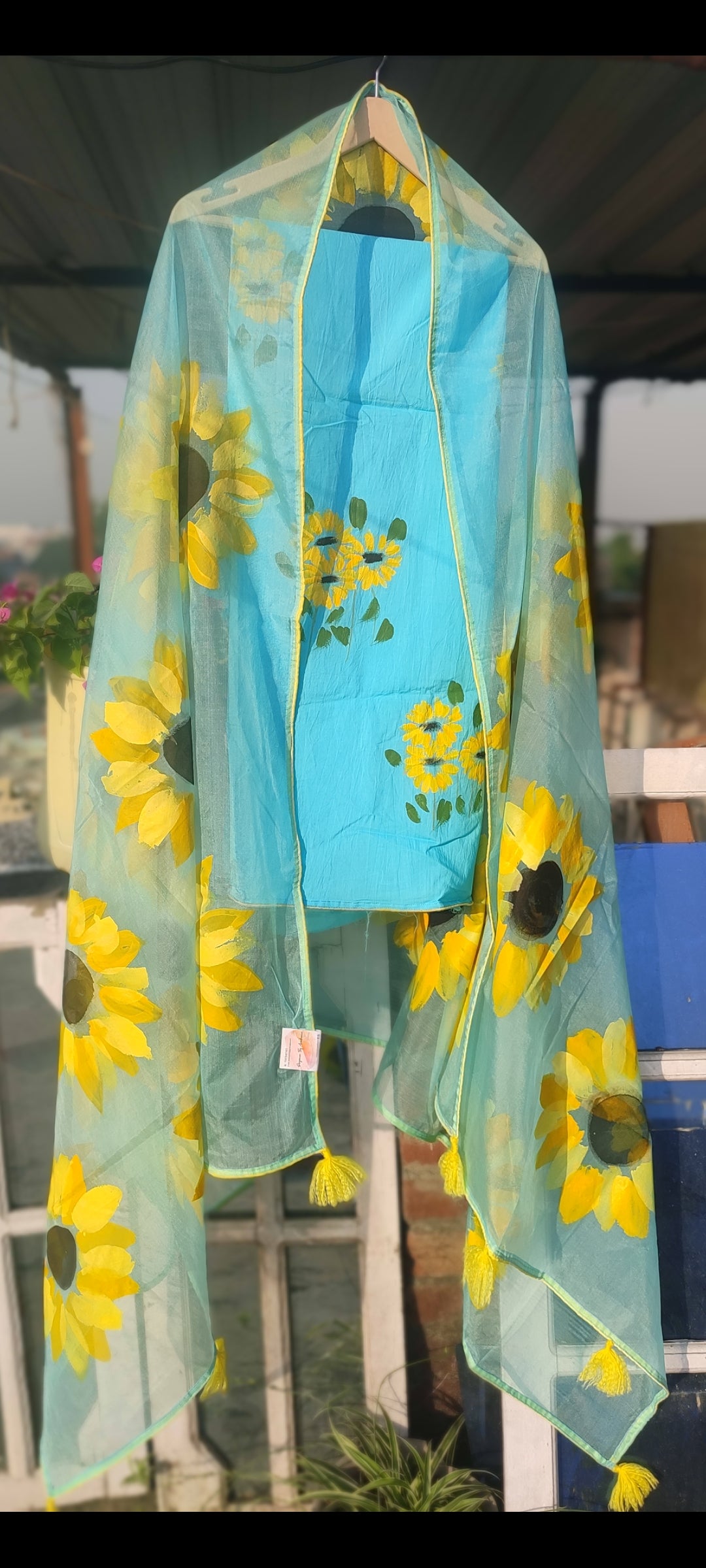 Hand painted sky blue suit with beautiful sunflowers and organza dupatta.