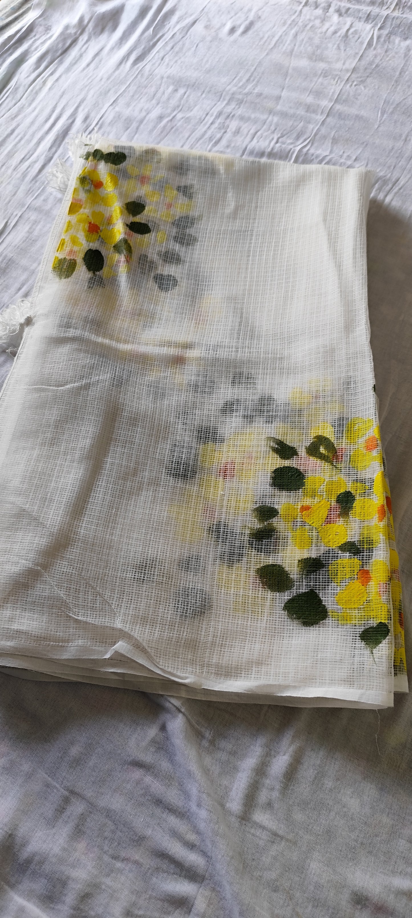 Hand-painted white pure kota doria suit with yellow flowers.
