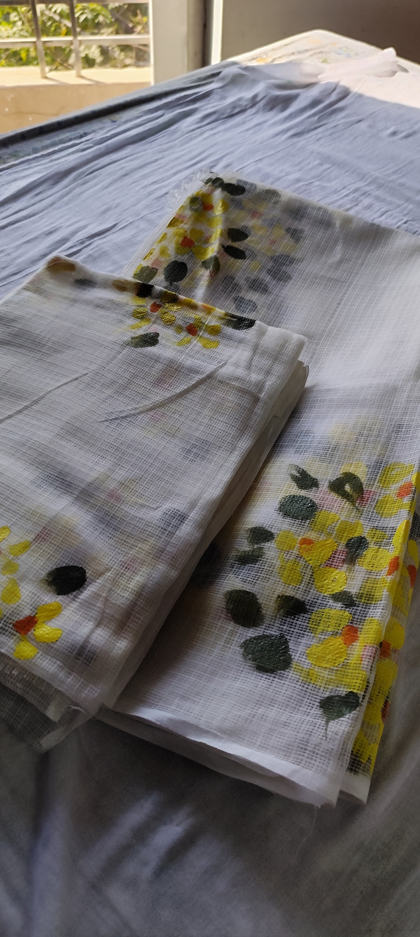 Hand-painted white pure kota doria suit with yellow flowers.