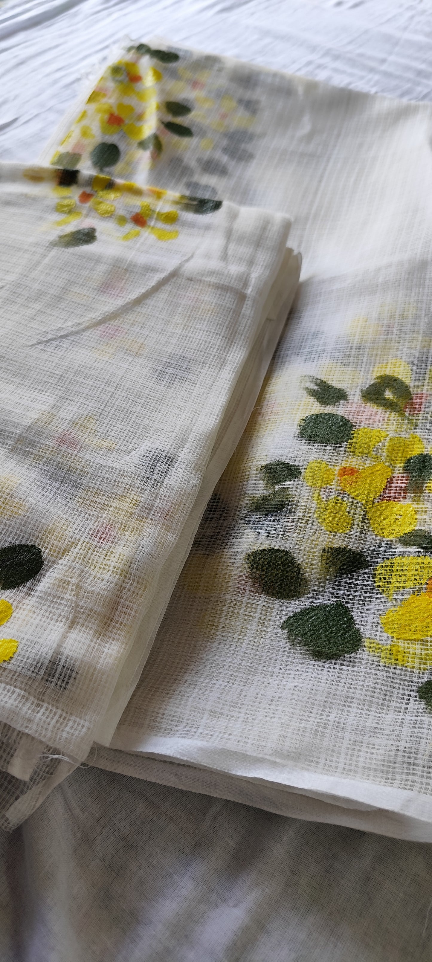 Hand-painted white pure kota doria suit with yellow flowers.