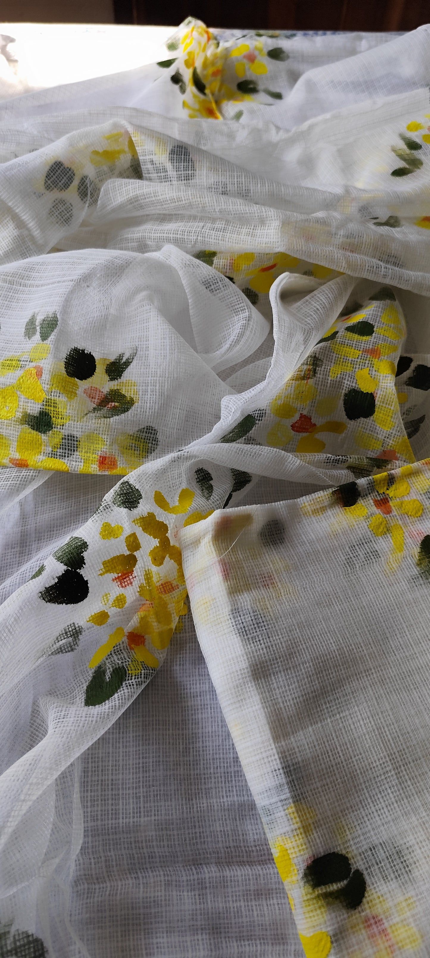 Hand-painted white pure kota doria suit with yellow flowers.