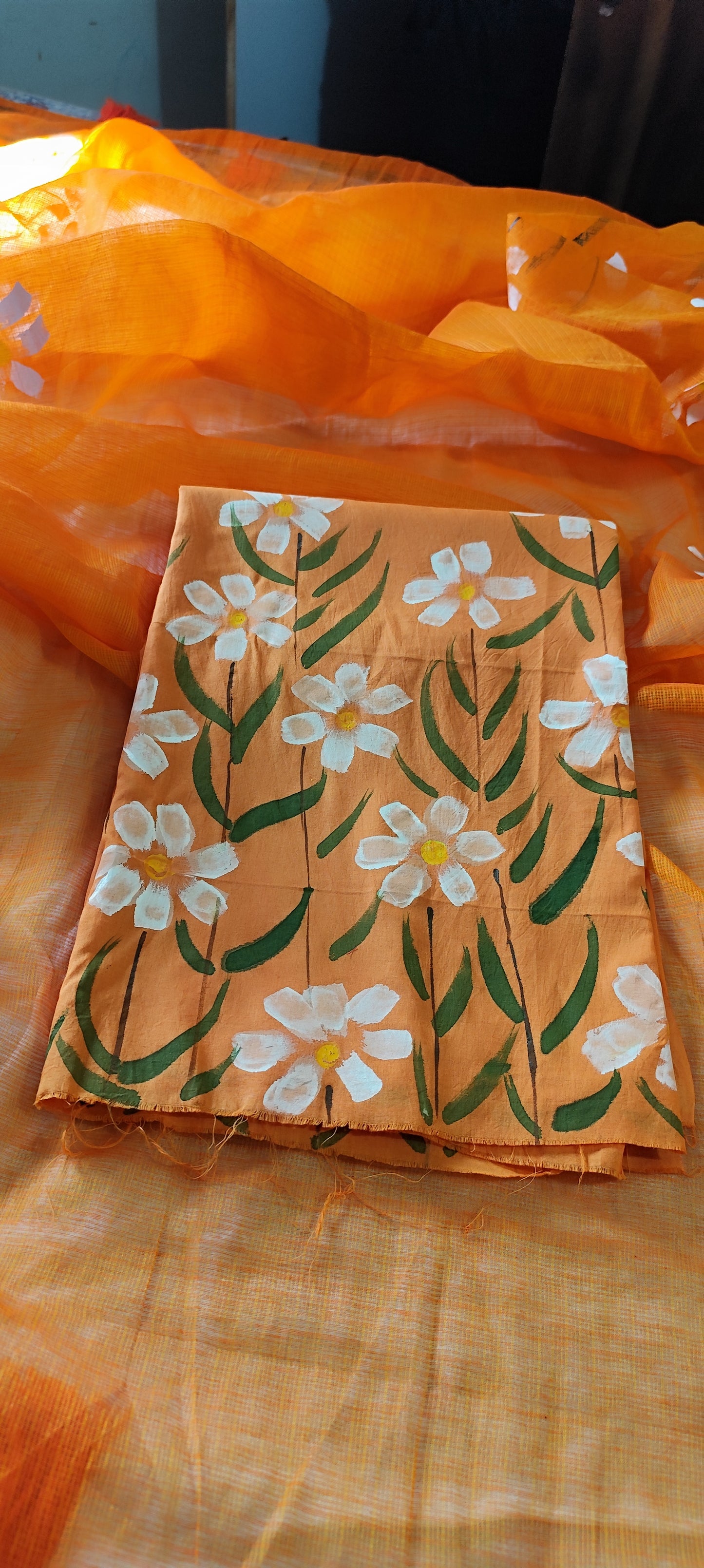 Handpainted orange pure cotton suit with white blossoms and kota doria dupatta