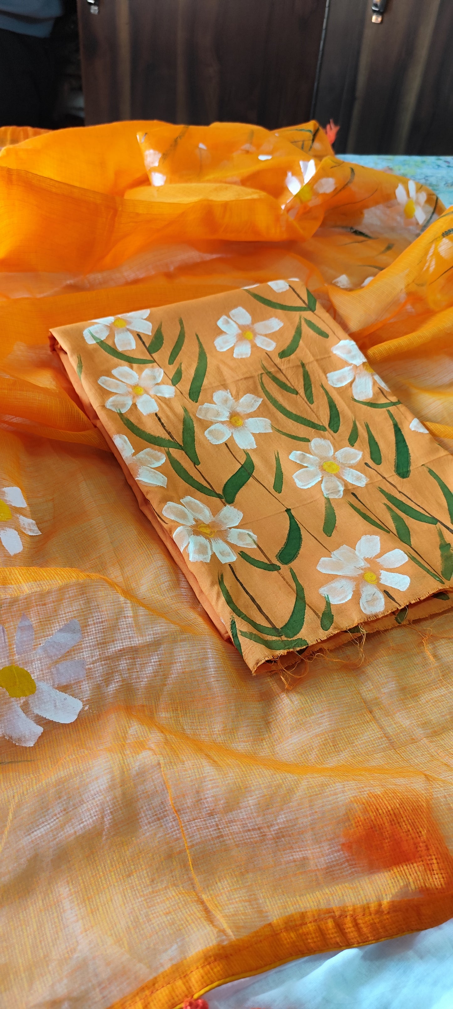 Handpainted orange pure cotton suit with white blossoms and kota doria dupatta